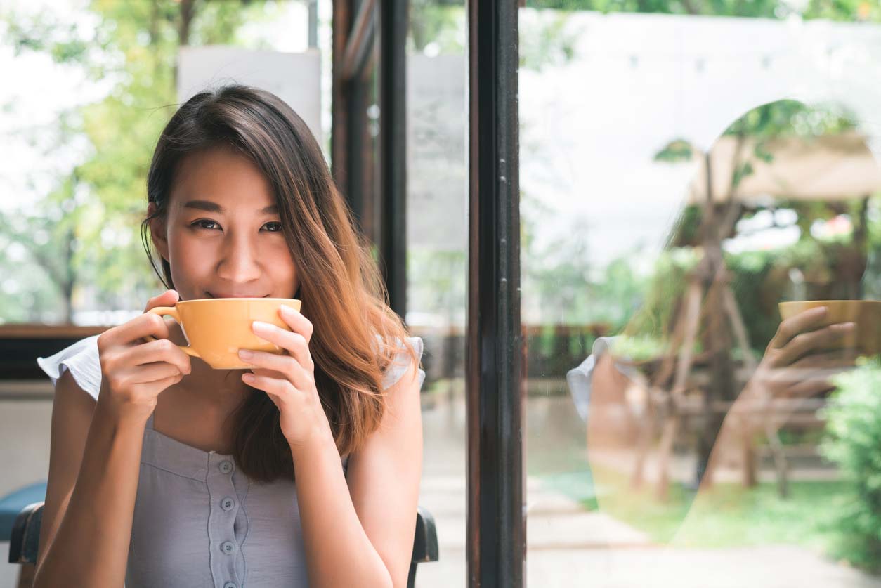 woman enjoying cup of coffee or tea