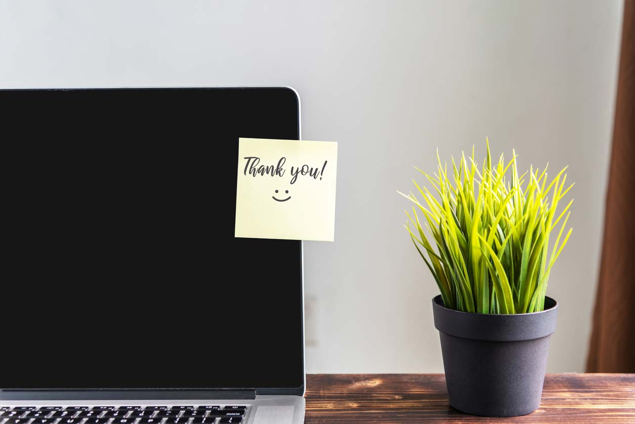sticky note on laptop screen saying thank you