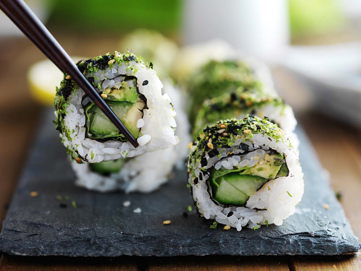 kale vegan sushi rolls on board