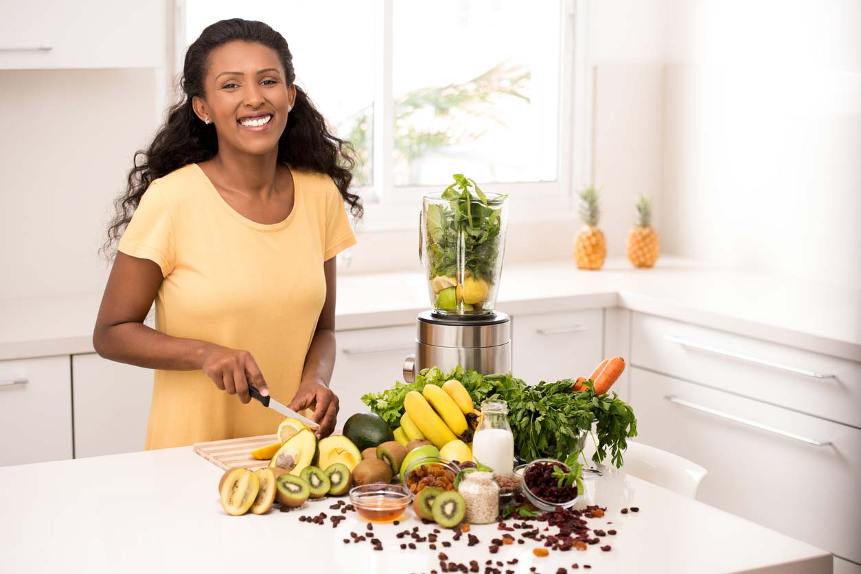 Smiling woman in kitchen getting magnesium health benefits from food