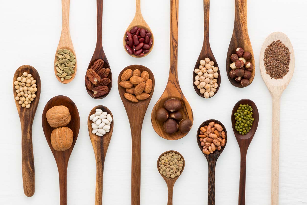 Wooden spoons holding foods high in phytic acid that converts to phytates